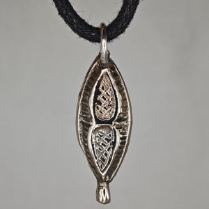 Authentic medieval amulet in the form of a leaf. Medieval artifacts. Medieval pendant. Medieval amulet. Medieval jewelry. Medieval pendant.