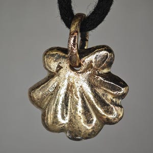 May include: A set of three ceramic mugs with a speckled, matte finish. The mugs are in shades of cream, light gray, and dark gray. Each mug has a simple, minimalist design and a rounded handle.