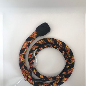 May include: A black and orange braided whip with a black knotted handle.