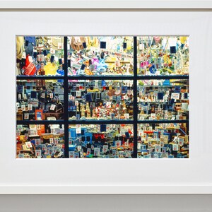May include: A shop window display filled with a variety of small items, including toys, trinkets, and other miscellaneous goods. The items are arranged in a grid pattern and are all tagged with price labels.