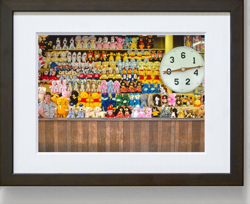 May include: A wall filled with colorful stuffed animals, including bears, bunnies, and other creatures. A large clock with black numbers on a white face is mounted on the wall. The clock reads 6:00.
