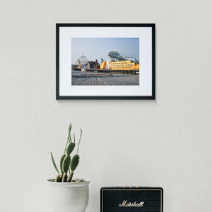 May include: A framed photograph of a yellow and orange amusement park ride with the text "Whirly's Fun Presents - Old Country Jubilee" on a wooden boardwalk.