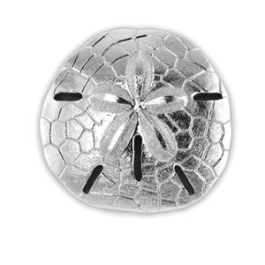 May include: A shiny, silver sand dollar with a detailed, textured surface. The sand dollar has a star-like pattern in the center and five symmetrical slots. The object is set against a plain white background.
