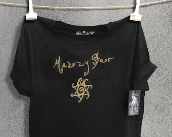 May include: Black t-shirt with a gold glitter design featuring a stylized sun and the text "Mazzy Star".