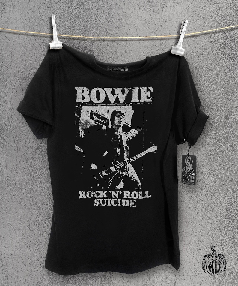 May include: Black t-shirt with a white graphic of David Bowie playing guitar with the text "BOWIE" and "ROCK 'N' ROLL SUICIDE" printed on the front.