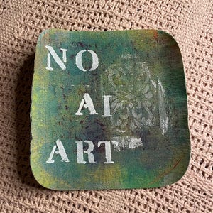 May include: A square, green, and yellow canvas with the words "NO AI ART" painted in white.
