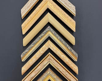 May include: Eight different picture frames with ornate gold and silver finishes. The frames are arranged in a pyramid shape, with the largest frame at the top and the smallest frame at the bottom.