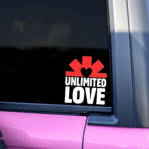 May include: A black and white sticker with a red heart and the words "Unlimited Love" on a pink car.