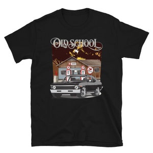 May include: Black t-shirt with a vintage illustration of a black Chevrolet Nova muscle car in front of a gas station with the text "Old School" above the car.