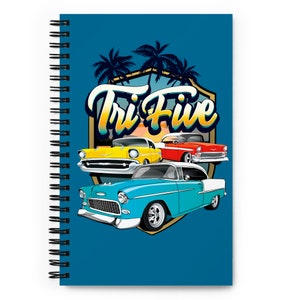 May include: Spiral-bound notebook with a blue cover featuring a graphic of classic cars in yellow, red, and blue. The design includes the text "Tri Five" in a retro font, palm trees, and a shield.