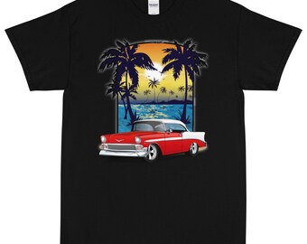 May include: A black t-shirt featuring an illustration of a red and white classic car in front of a sunset scene with palm trees.
