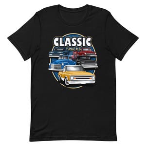 May include: Black t-shirt with a graphic of classic trucks. The trucks are yellow, blue, red, and black. The text "CLASSIC TRUCKS" is above the trucks.