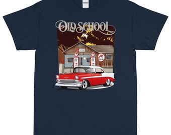 May include: Navy blue t-shirt with a graphic of a red and white classic car parked outside a vintage petrol station. The words "Old School" are displayed above the car. The design has a retro, automotive theme.