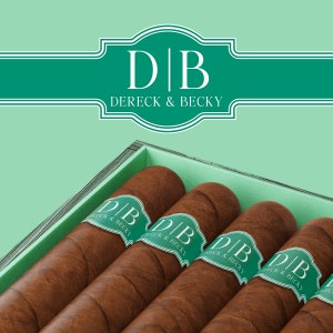 May include: A wooden box with four brown cigars inside. Each cigar has a green band with the text "DB Dereck & Becky" printed on it.