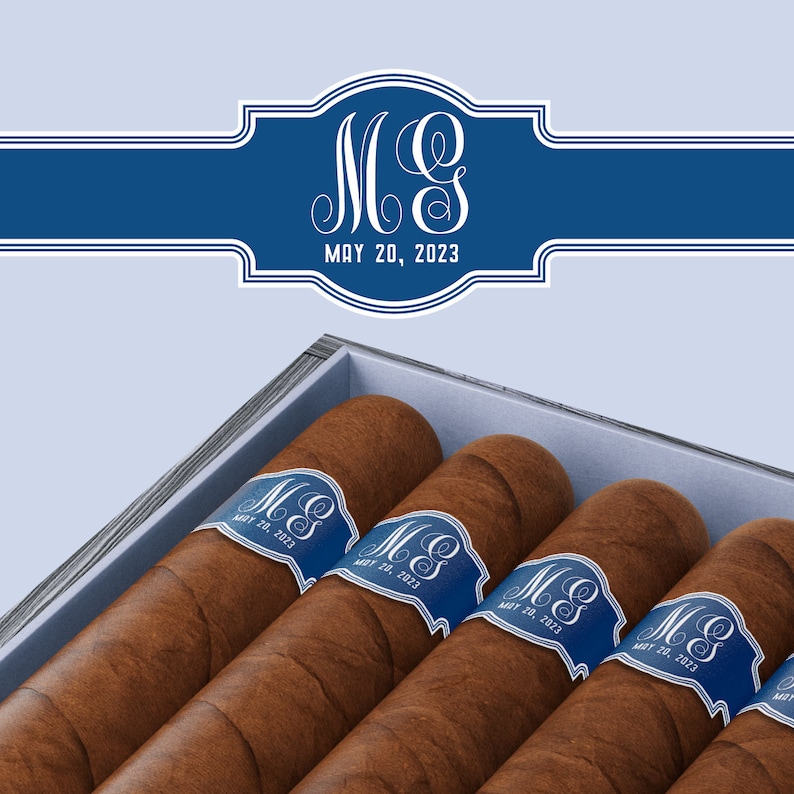 May include: A wooden box of cigars with blue and white labels. The labels have the initials "M&S" and the date "MAY 20, 2023".