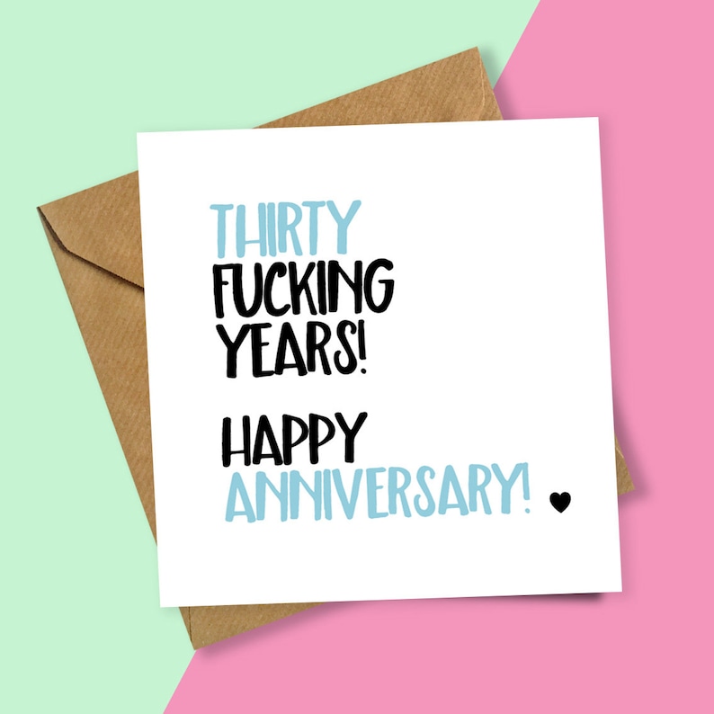 May include: A white card with the text "Thirty Fucking Years! Happy Anniversary!" in black and blue lettering. A small black heart is at the end of the text.