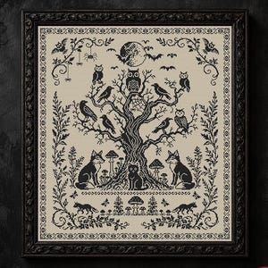 May include: A framed cross-stitch embroidery featuring a black ink design on a beige fabric background. The pattern depicts a central gnarled tree filled with owls and crows, surrounded by foxes, a cat, mushrooms, bats, and a full moon.