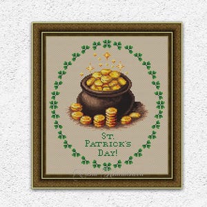 May include: Cross-stitch design featuring a pot of gold coins, surrounded by a green shamrock border, with the text "St. Patrick's Day!" in a framed presentation. The design is on a beige background.