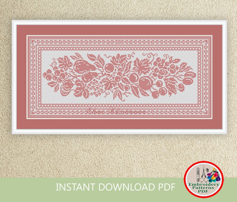 May include: A cross stitch pattern featuring a floral design with fruit and leaves. The pattern is in a white and pink color scheme and is framed in a white frame.