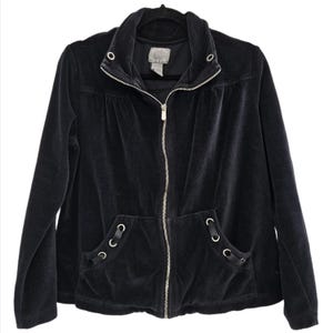 May include: A black velour zip-up jacket featuring a high collar with silver-tone metal grommets, a full-length silver zipper, and two front pockets accented with black ribbon lacing threaded through silver-tone metal grommets at the corners.