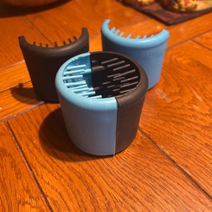 May include: Three blue and black silicone hair detangling brushes. The brushes are designed to detangle hair without pulling or breaking it.