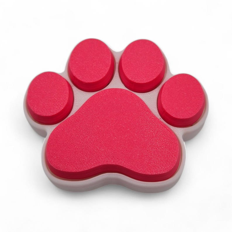 May include: A red paw-shaped object with five rounded pads. The paw is set on a light gray base. The object is a pet-themed item, likely a decorative piece or a functional item for pet owners.