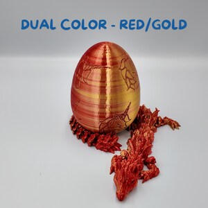 May include: A red and gold 3D printed dragon egg with a dragon curled around the base. The egg is decorated with a pattern of unicorns.