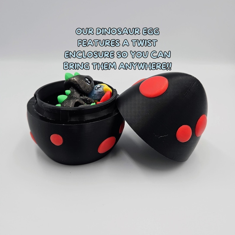 May include: A black and red dinosaur egg-shaped container with a twist closure. The container is open and three small dinosaur figurines are inside. The text on the image reads "OUR DINOSAUR EGG FEATURES A TWIST ENCLOSURE SO YOU CAN BRING THEM ANYWHERE!!"