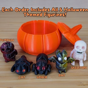 May include: Five Halloween-themed figurines, including a pumpkin, cat, spider, bat, and skeleton, are displayed on a wooden surface. The figurines are arranged in a semi-circle around an orange pumpkin-shaped container with a lid. The text "Each Order Includes All 5 Halloween Themed Figurines!" is displayed at the top of the image.