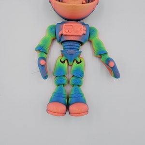 May include: A 3D printed astronaut figurine with a rainbow gradient color scheme. The astronaut has a human face and is wearing a helmet. The figurine is articulated and has movable arms and legs.