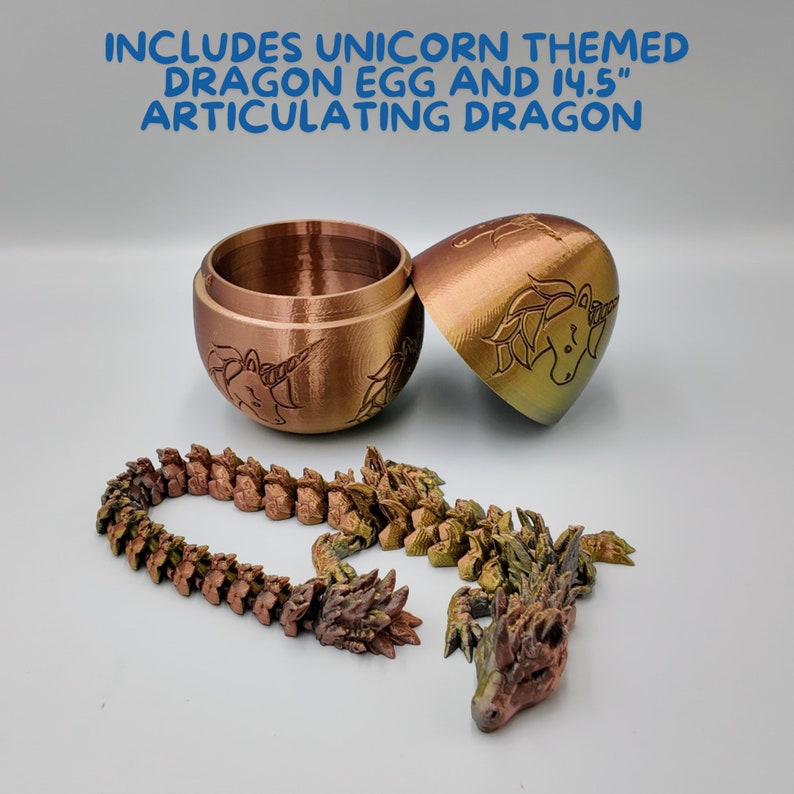 May include: A gold and green articulated dragon toy with a unicorn design. The dragon is made up of multiple connected pieces and comes with a matching dragon egg. The egg is a small, round container with a lid.