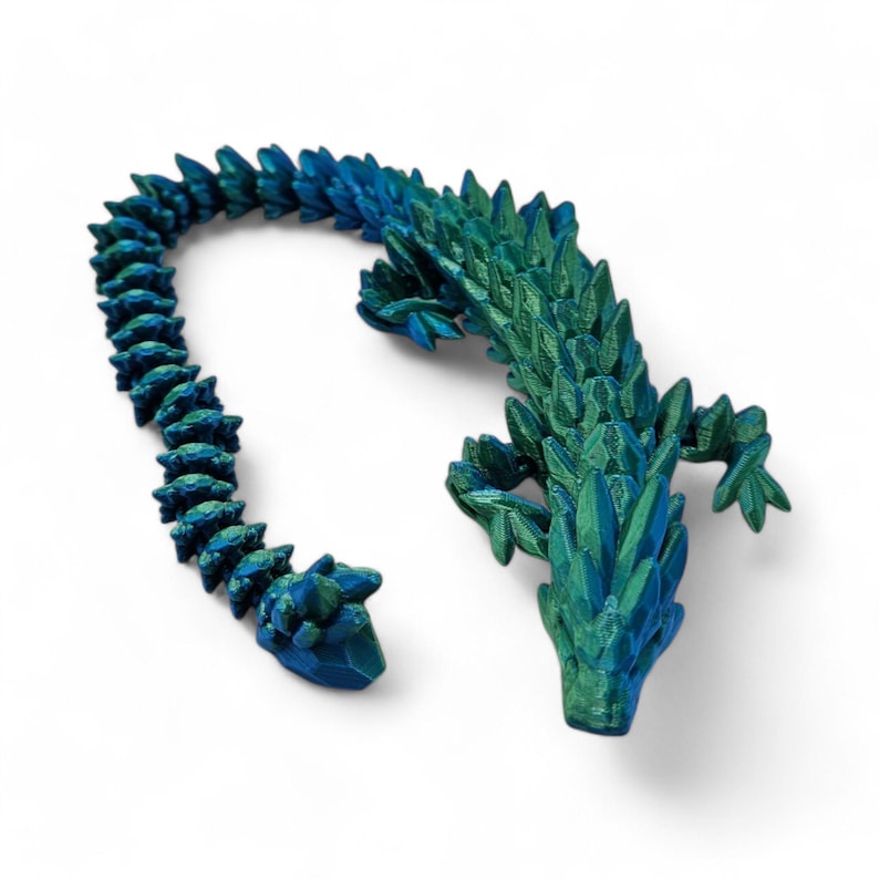 May include: A 3D printed green and blue dragon figurine with a segmented tail.