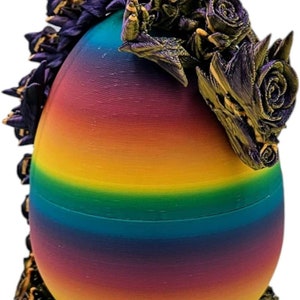 May include: A rainbow egg with a purple and gold dragon head with roses around the top and bottom.