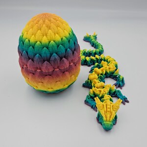 May include: A rainbow colored dragon egg with a matching dragon hatching from the egg. The dragon is made of plastic and is about 6 inches long.