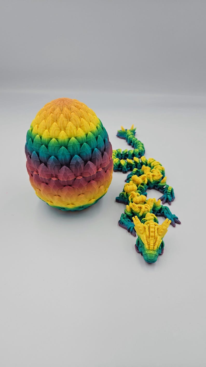 May include: A rainbow colored dragon egg with a matching dragon hatching from the egg. The dragon is made of plastic and is about 6 inches long.