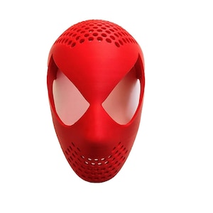 May include: A bright red mask with a design reminiscent of a superhero. The mask has large, white eye openings and a perforated top and lower section. The mask is likely made of plastic or a similar material.