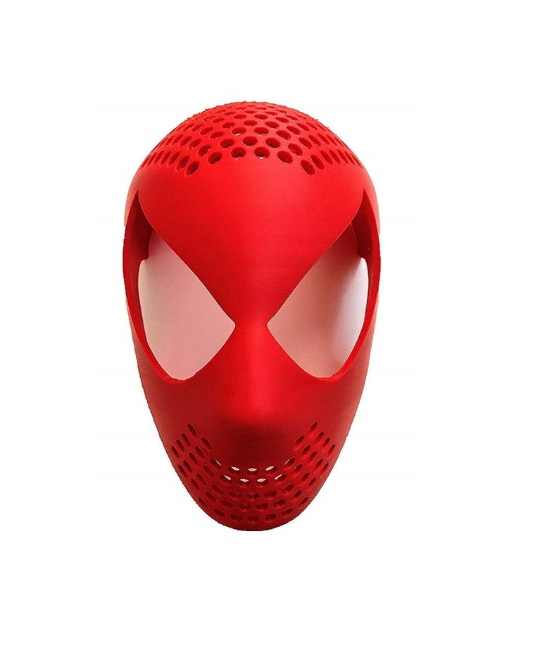 May include: A bright red mask with a design reminiscent of a superhero. The mask has large, white eye openings and a perforated top and lower section. The mask is likely made of plastic or a similar material.