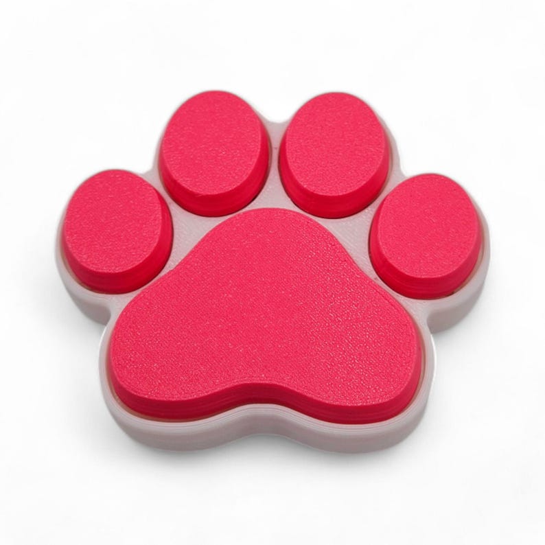 May include: A red and gray paw-shaped object. The paw has five rounded pads in a vibrant red color, set against a light gray base. The design is a playful representation of a pet's paw.
