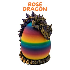 May include: A rainbow-colored egg-shaped object with a dragon head made of purple and gold roses. The text "ROSE DRAGON" is written in orange above the object.