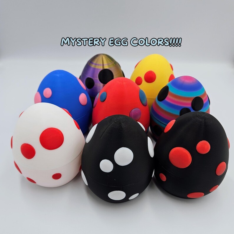 May include: Eight colorful speckled Easter eggs with a variety of patterns and colors, including red, white, black, blue, yellow, and purple. The eggs are arranged in a circle on a white surface. The text "MYSTERY EGG COLORS!!!" is written in blue letters at the top of the image.