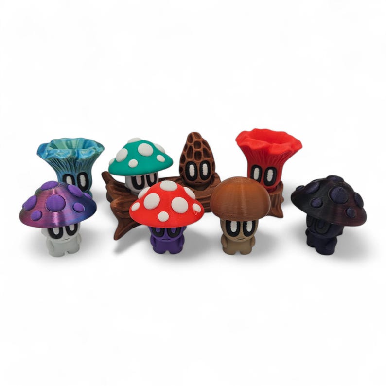 May include: A collection of whimsical mushroom figurines in various colors, including purple, red, green, and brown. Each mushroom has a unique design and is set against a white background. The figurines have a cartoonish appearance.