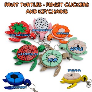 May include: A set of ten colorful fruit-shaped turtle keychains. Each turtle has a different fruit design, including strawberry, dragonfruit, orange, watermelon, kiwi, apple, banana, and blueberry. The turtles are made of plastic and have a clicker function.