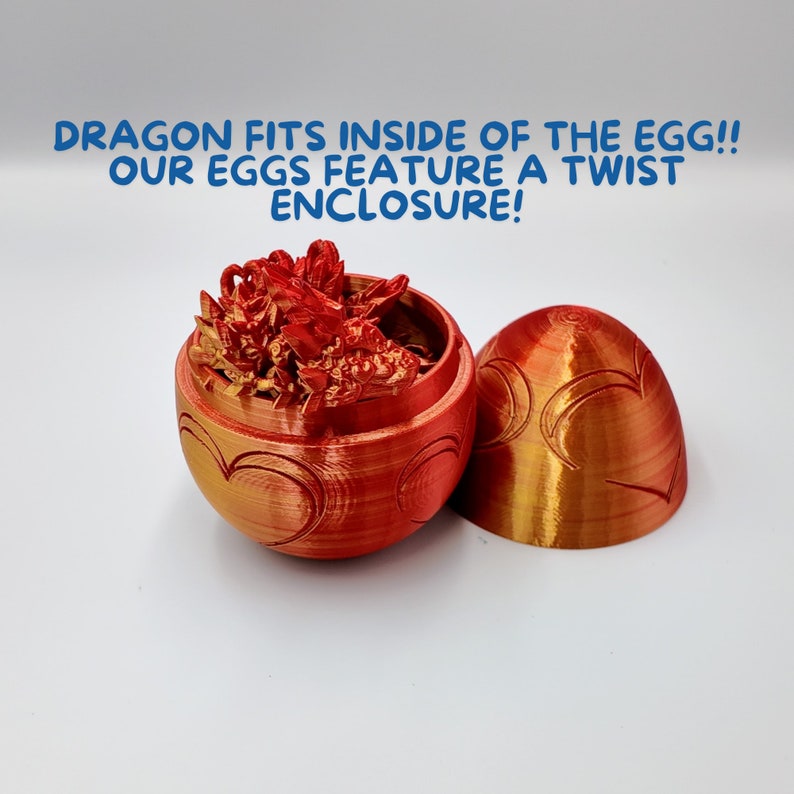 May include: A red and gold dragon figurine fits inside a red egg with a heart design. The egg is open and the dragon is visible inside. The text "DRAGON FITS INSIDE OF THE EGG!! OUR EGGS FEATURE A TWIST ENCLOSURE!" is visible above the egg.