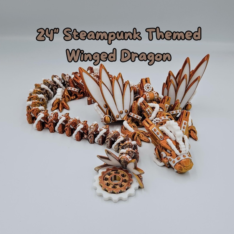 May include: A 24-inch steampunk-themed winged dragon made of white and copper-coloured plastic. The dragon has intricate details, including gears, cogs, and other mechanical elements. The wings are spread out and the dragon's head is turned to the side.