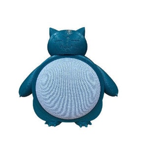 May include: A teal blue 3D printed speaker shaped like a cartoon character. The speaker has a light blue front with a textured pattern.