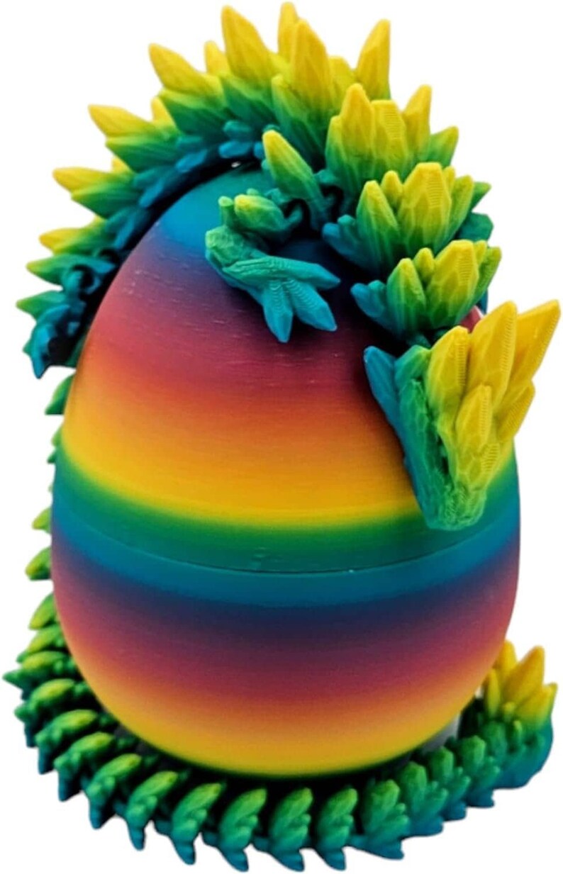 May include: A rainbow-coloured egg with a green and yellow dragon curled around it. The dragon has a spiky back and a curled tail.