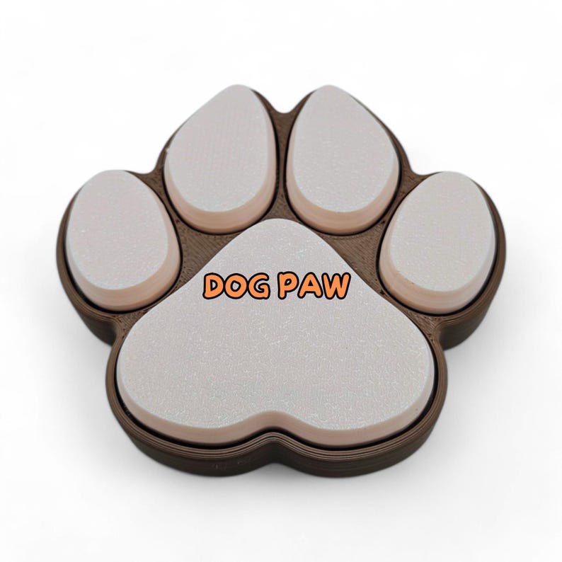May include: A brown and white dog paw-shaped object with the text "DOG PAW" in orange. The paw has five white pads and a brown outline. The object is likely a decorative item or a pet-related product.