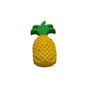 May include: A yellow pineapple-shaped object with a green leafy top. The pineapple has a textured surface and is set against a white background. This decorative item is a tropical fruit-themed product.