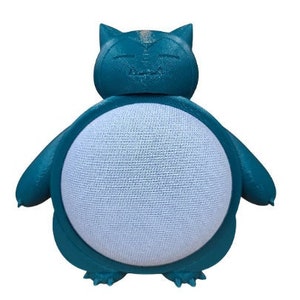 May include: A teal blue 3D printed Pokemon character, resembling a Snorlax, designed to hold a smart speaker. The character has a white, textured surface where the speaker would sit.