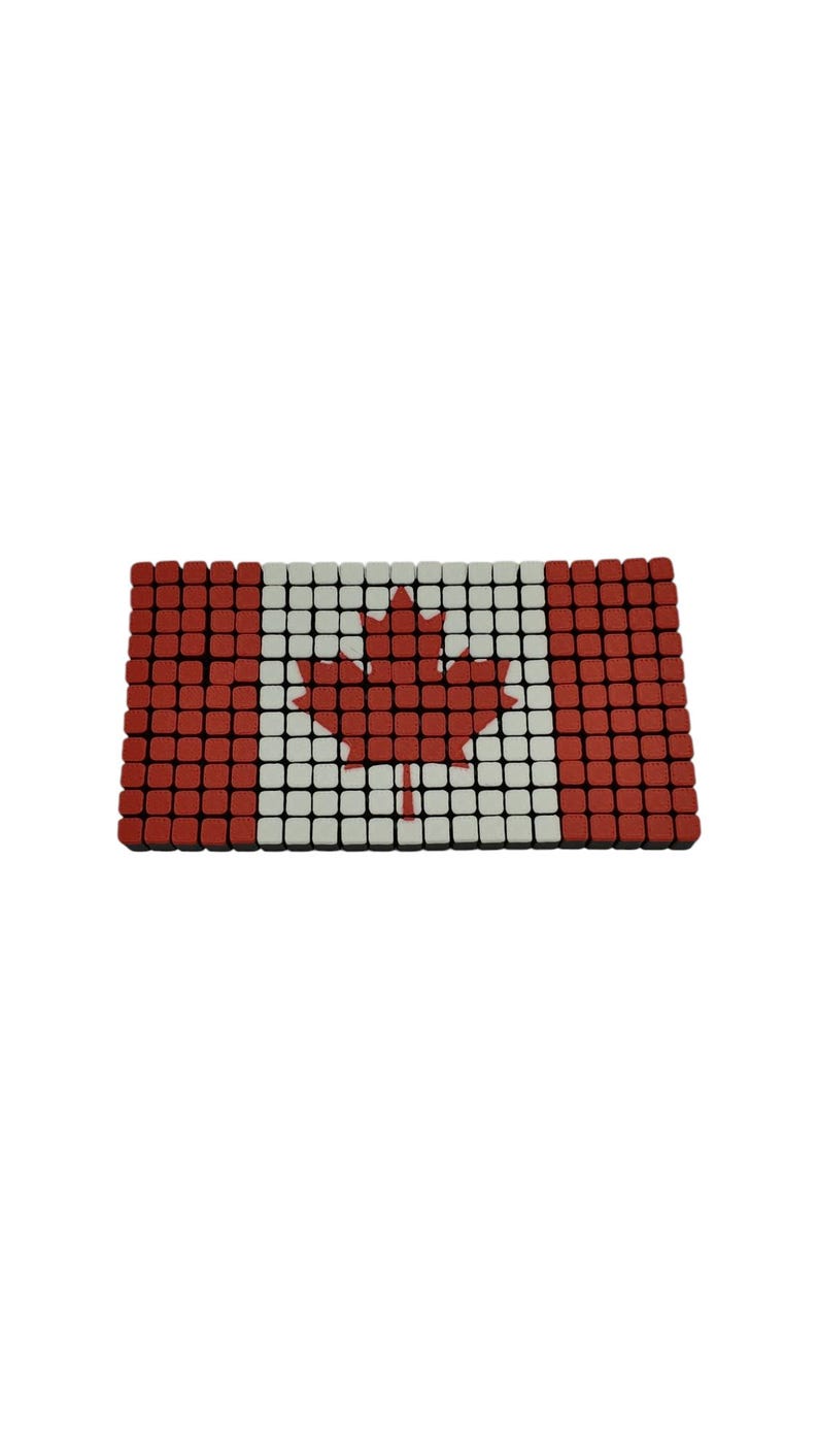 Pode incluir: Objeto retangular que representa a bandeira canadense. O design &eacute; composto por pequenas telhas quadradas vermelhas, brancas e vermelhas. Uma folha de bordo vermelha est&aacute; centrada em um fundo branco, com barras vermelhas em ambos os lados. Mede cerca de 20 cm de comprimento.